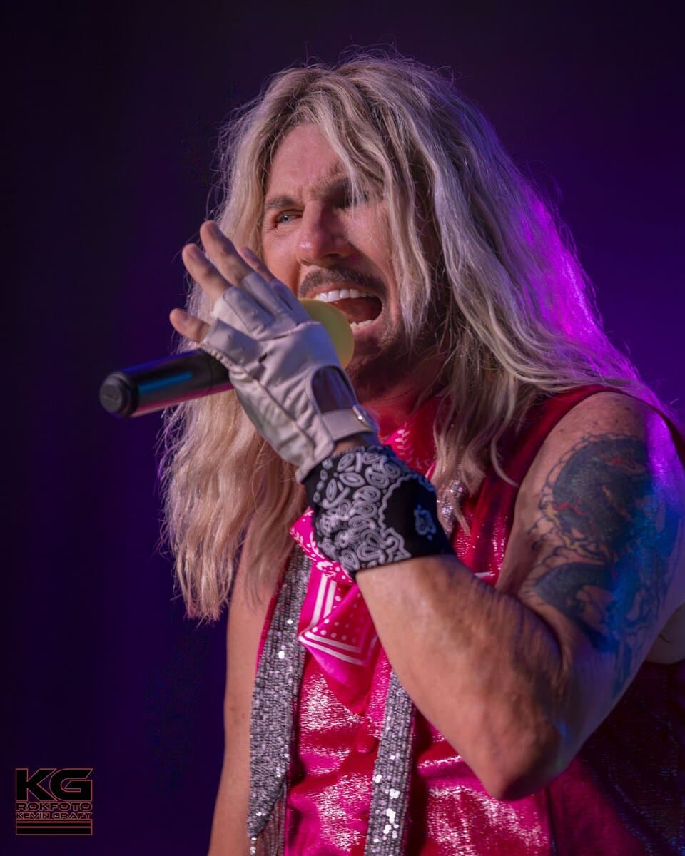 Gary Burnley, lead vocalist of BEST OF BOTH WORLDS, performing live with microphone in hand